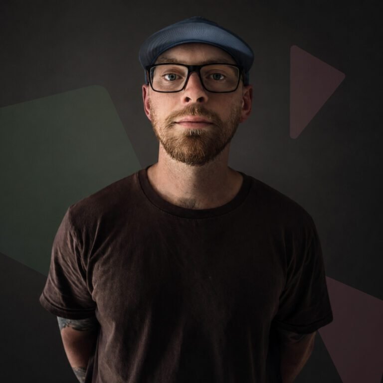 Christopher Livings | Remote Graphic Designer based in Chesterfield - Portrait Photo with green and pink shapes in the background