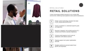 Retail Solutions slide with a video and image of a retail employee demonstrating a digital screen in-store