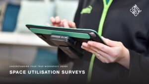 Space Utilisation Surveys slide for stakeholder reviews with an image of an emloyee at work using a tablet
